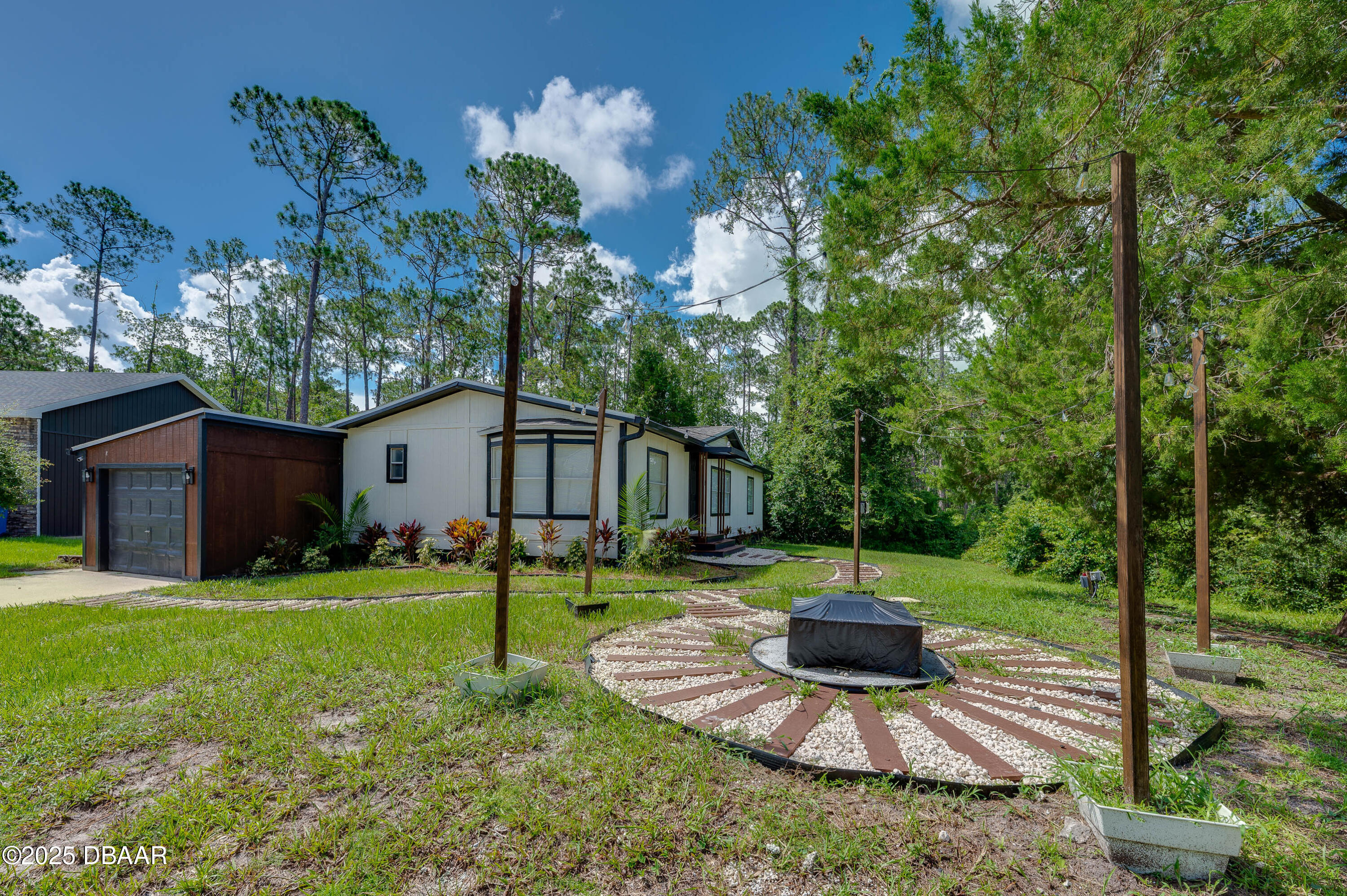 3669 General Marshall Road Daytona Beach, FL 32124 - Photo 3 of 32 a garden view with a seating space
