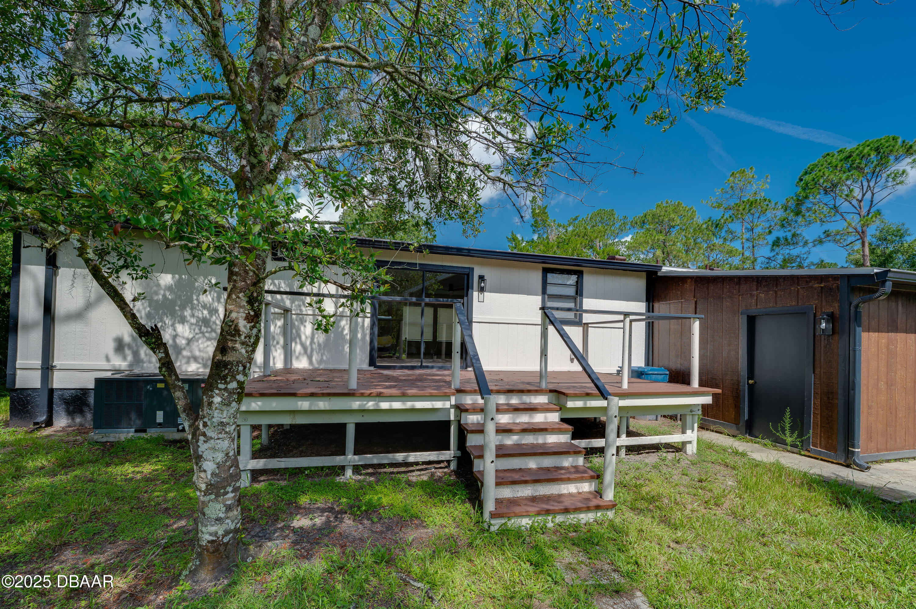 3669 General Marshall Road Daytona Beach, FL 32124 - Photo 4 of 32 a backyard of a house with table and chairs