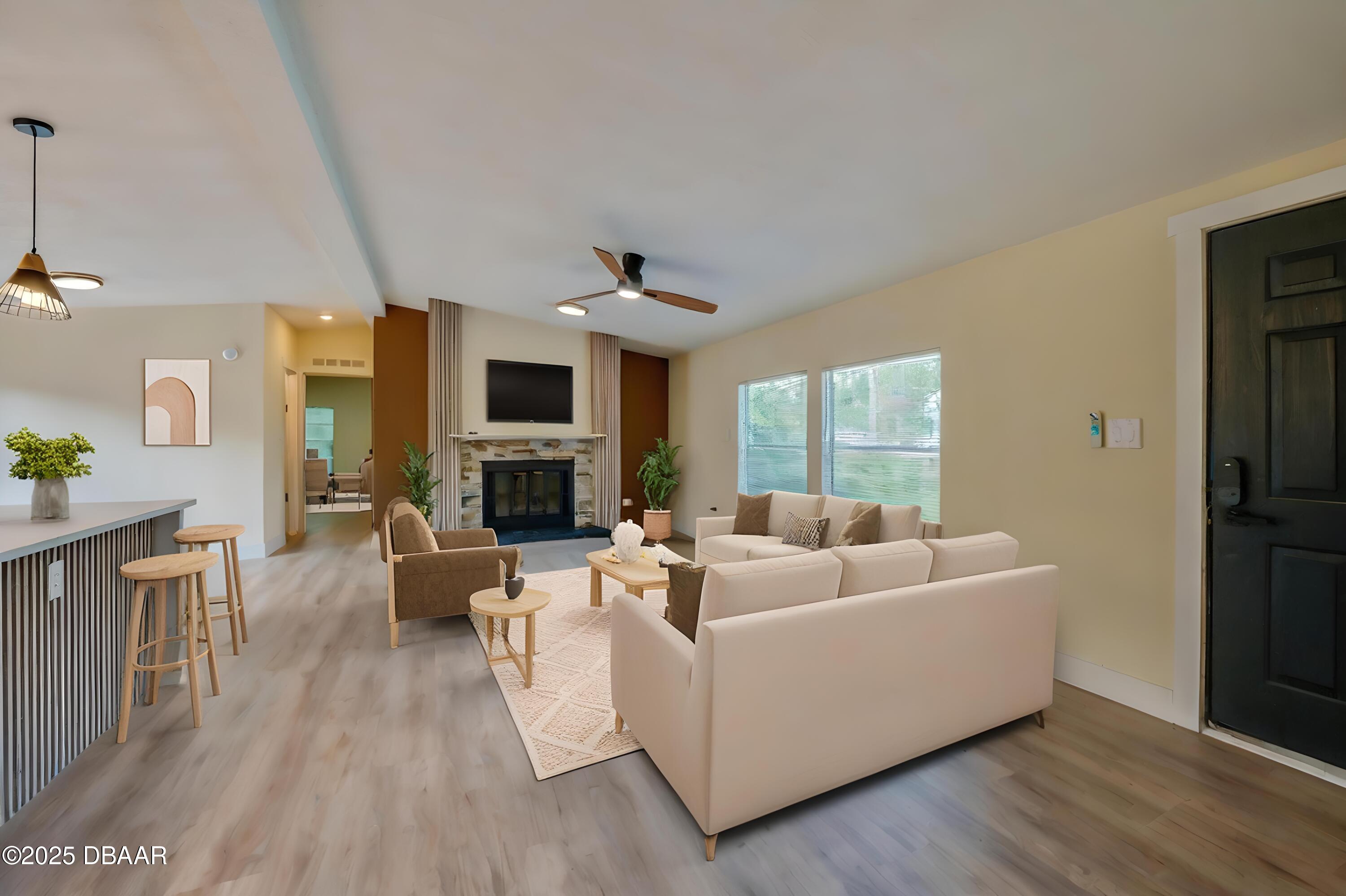 3669 General Marshall Road Daytona Beach, FL 32124 - Photo 6 of 32 a living room with furniture wooden floor and a fireplace