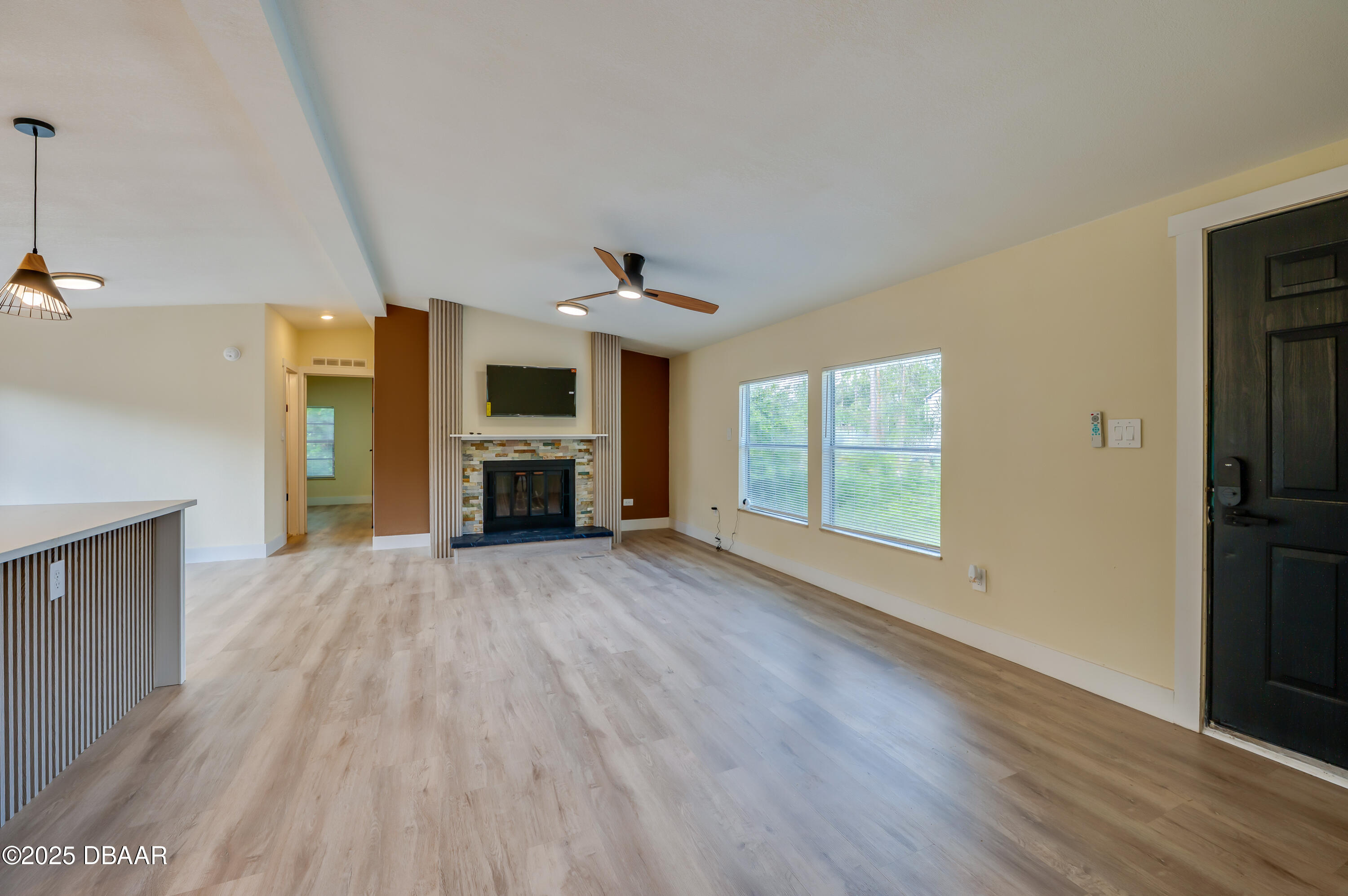 3669 General Marshall Road Daytona Beach, FL 32124 - Photo 7 of 32 a view of empty room with wooden floor and fireplace