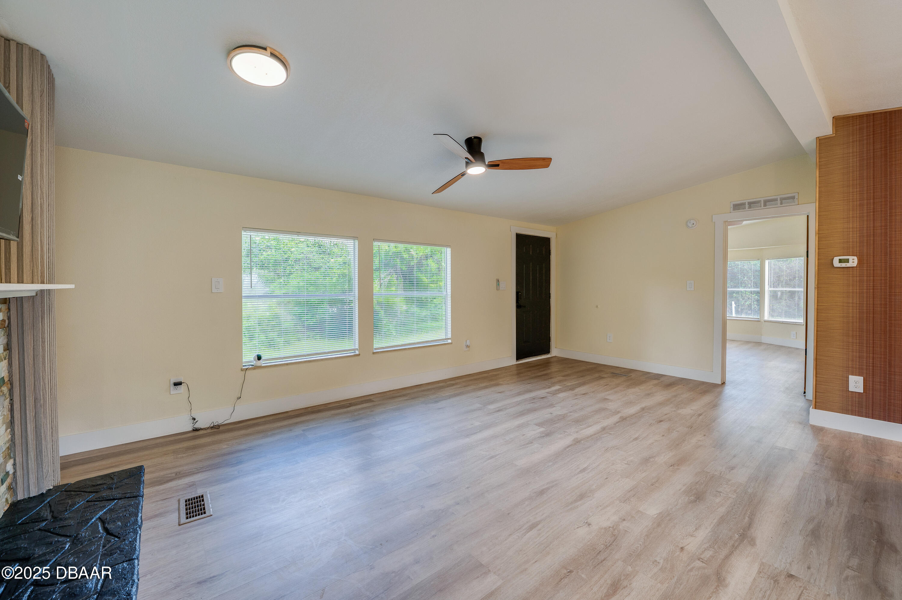 3669 General Marshall Road Daytona Beach, FL 32124 - Photo 8 of 32 a view of an empty room with wooden floor and a window