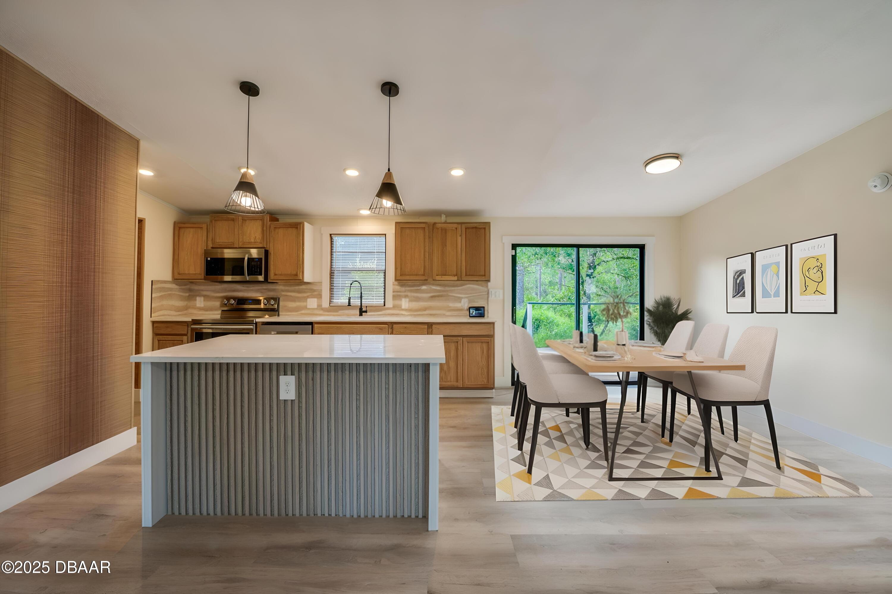 3669 General Marshall Road Daytona Beach, FL 32124 - Photo 10 of 32 a kitchen with stainless steel appliances granite countertop a stove top oven a sink dishwasher a dining table and chairs with wooden floor