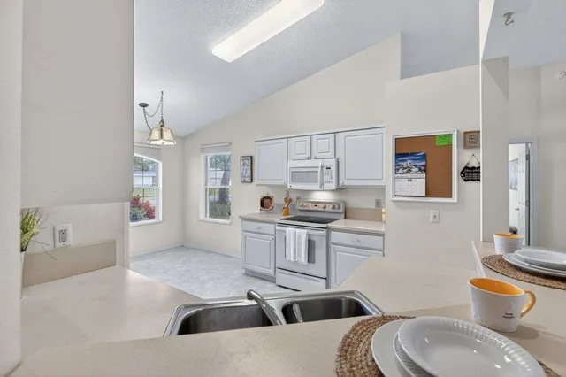 a view of a livingroom with a furniture wooden floor and a chandelier
