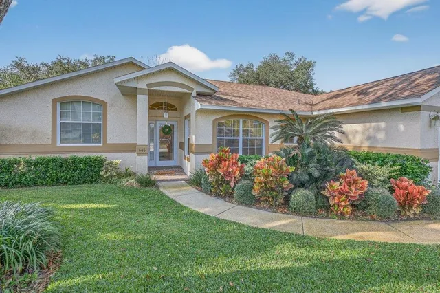 a front view of a house with a garden