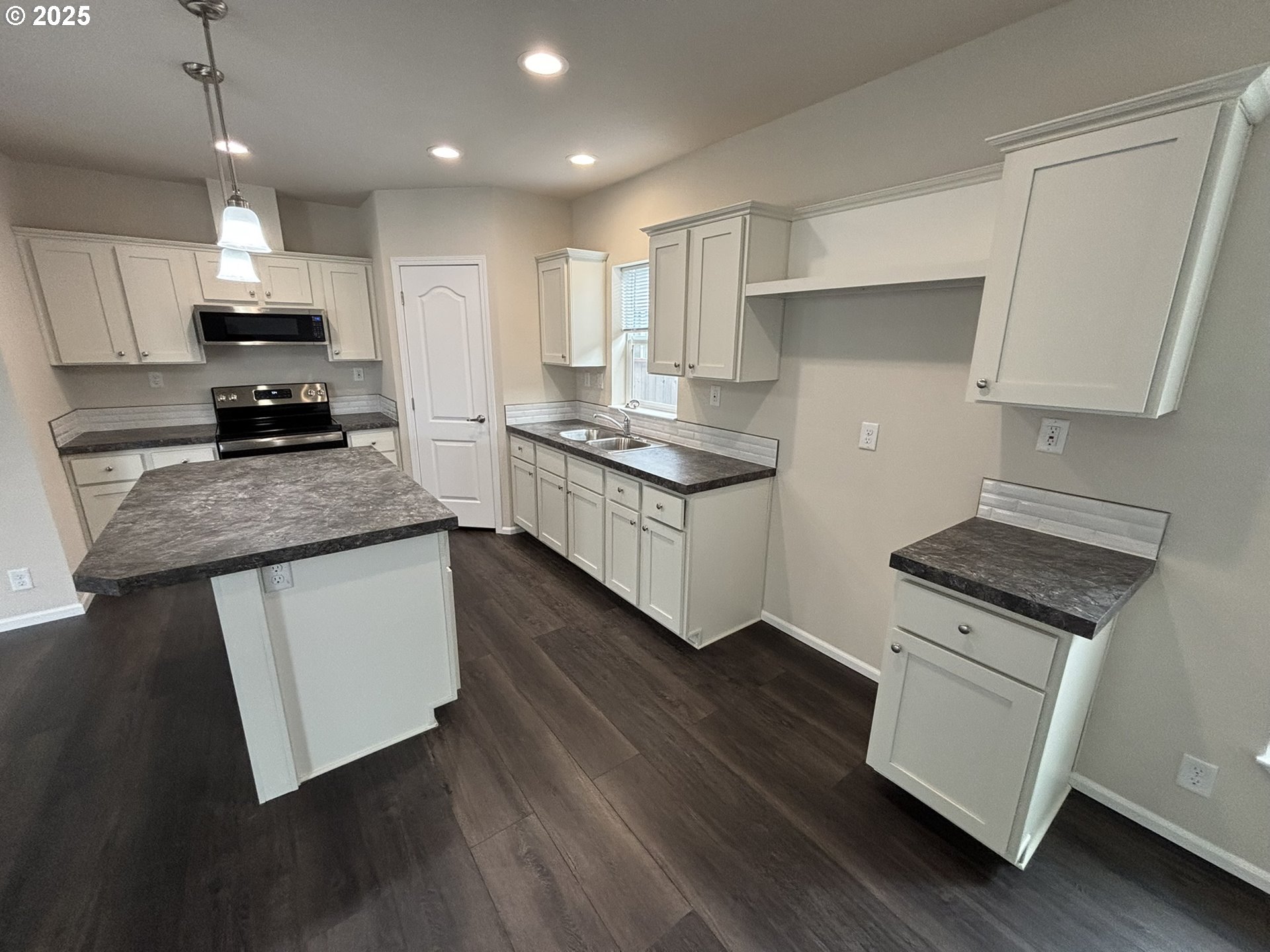 5270 Nopal Street Florence, OR 97439 - Photo 7 of 27 a kitchen with stainless steel appliances granite countertop a stove a sink and a refrigerator
