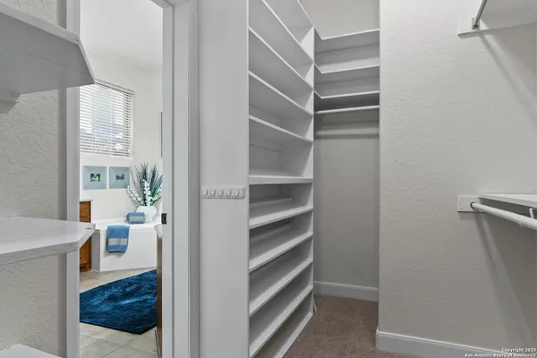 a living room with furniture ceiling fan and a window