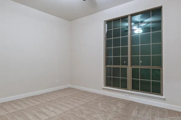 a view of swimming pool with lawn chairs and potted plants
