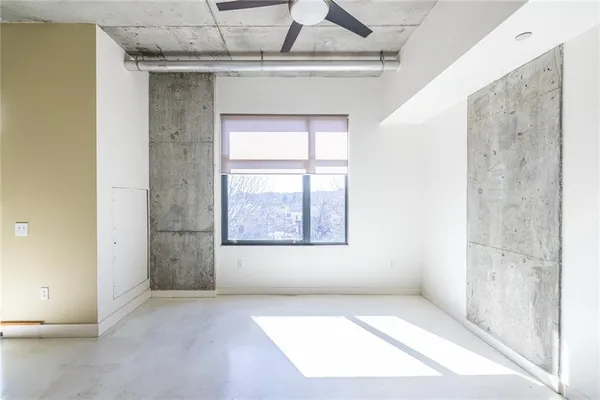 an empty room with a empty space and windows