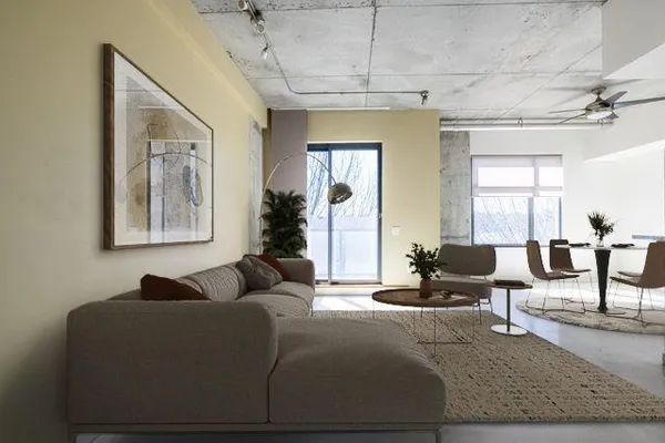 a living room with furniture and a painting on the wall