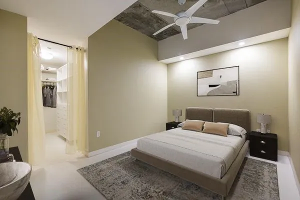 a bedroom with a bed and a mirror