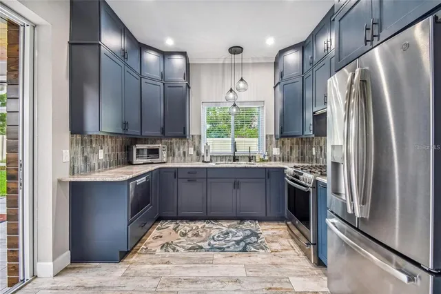 a open kitchen with stainless steel appliances granite countertop a stove and cabinets