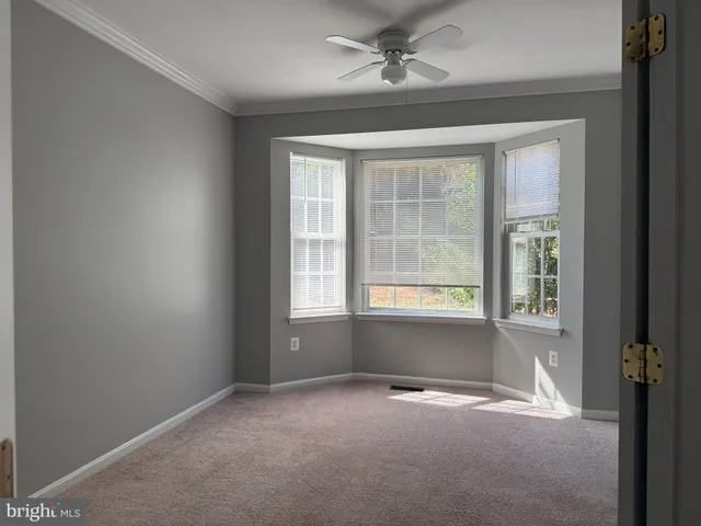 an empty room with a empty space and windows