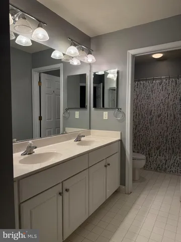 a bathroom with a double vanity sink and a mirror