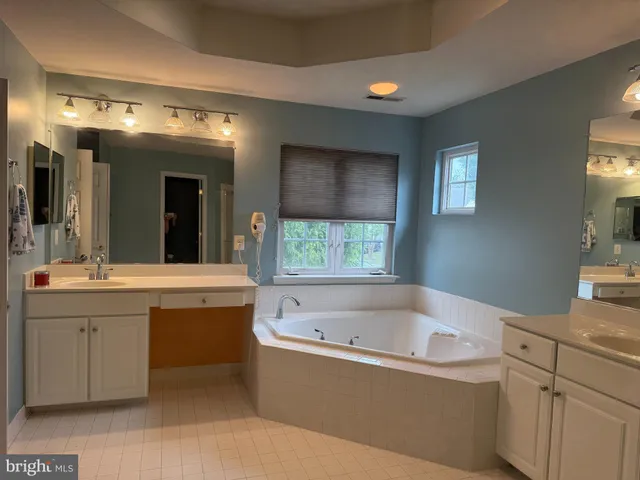 a bathroom with a bathtub and a sink