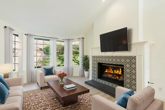 a living room with a fireplace with a flat screen tv