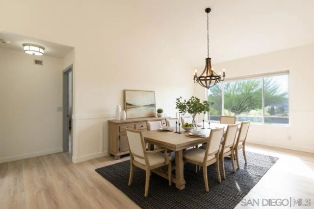 a view of a room with a window and a wooden floor