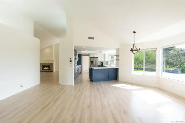 a kitchen with stainless steel appliances granite countertop a stove a microwave and a refrigerator