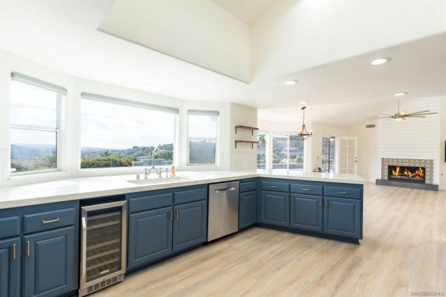 a kitchen with stainless steel appliances a refrigerator and wooden cabinets