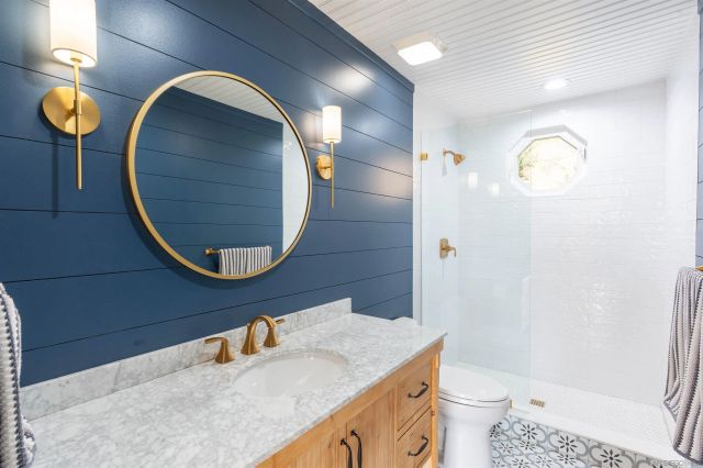 a spacious bedroom with a bed and wooden floor