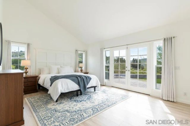 a bathroom with a double vanity sink a mirror and a large window