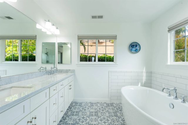 a white bath tub sitting next to a bathroom
