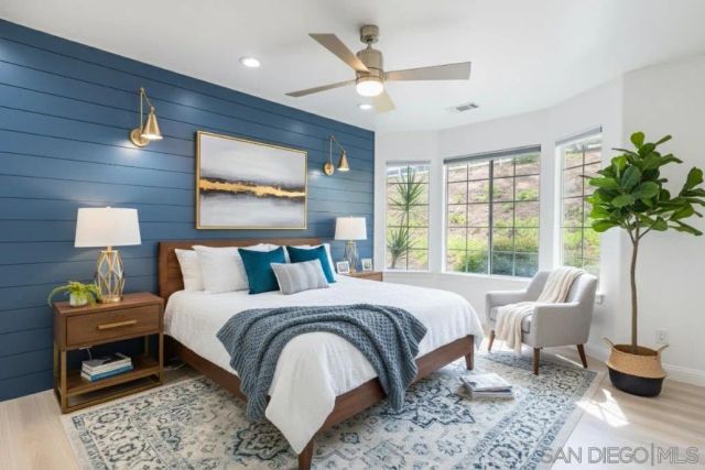 a bedroom with a bed and a ceiling fan