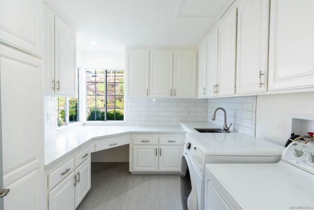 a front view of a house with a yard and mountain view in back