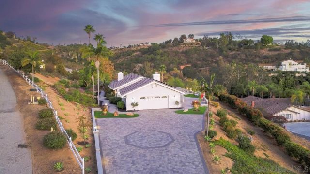 a front view of a house with a yard and fountain
