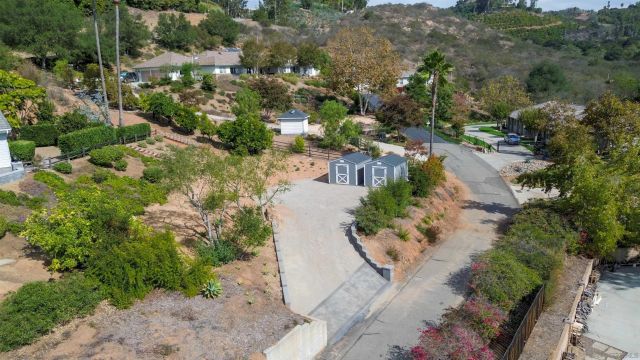 a front view of a house with yard and green space