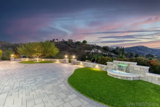 a view of a house with backyard and trees