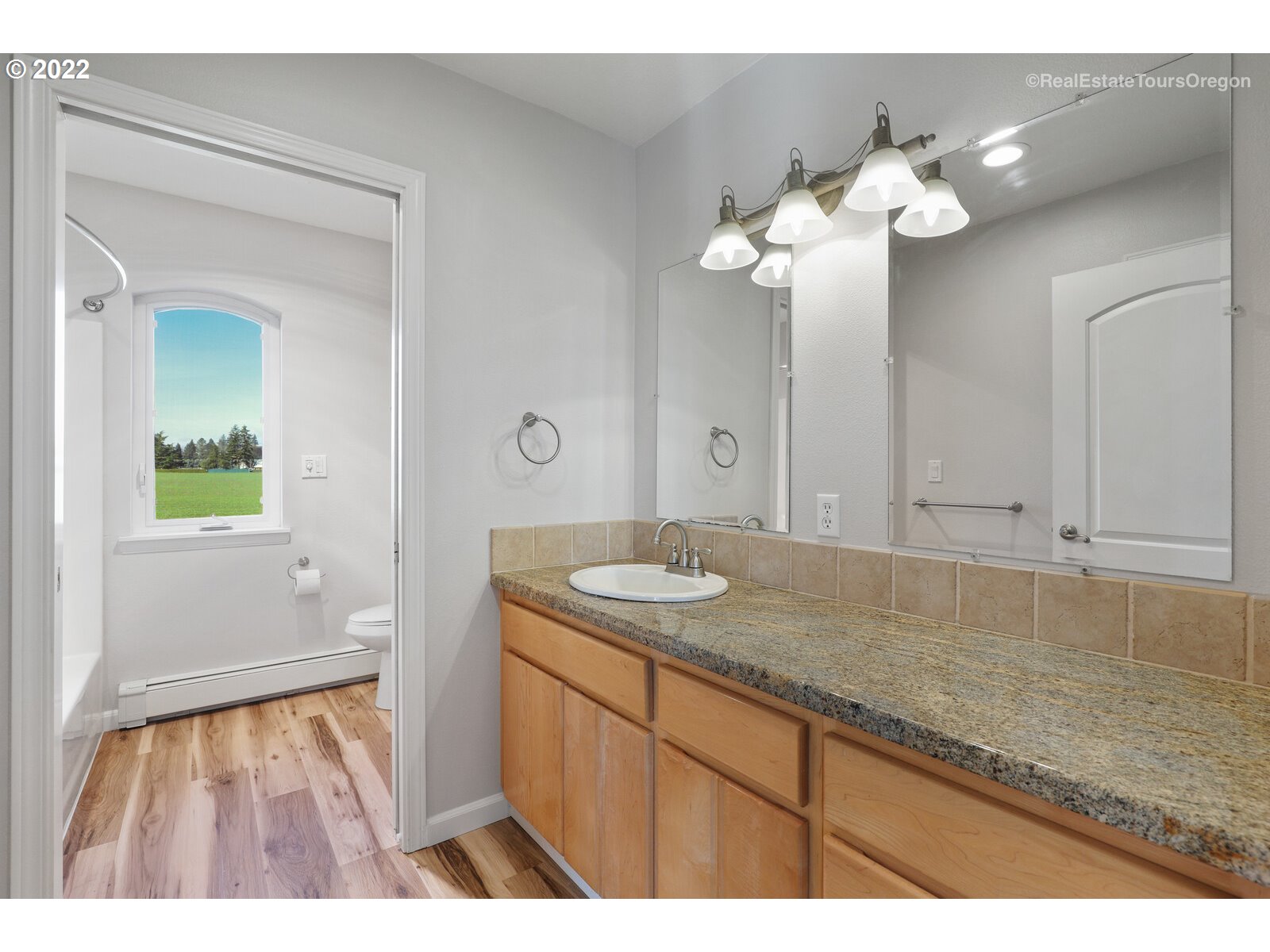 6360 Southwest Minter Bridge Road Hillsboro, OR 97123 - Photo 24 of 32 a bathroom with a granite countertop sink and a mirror