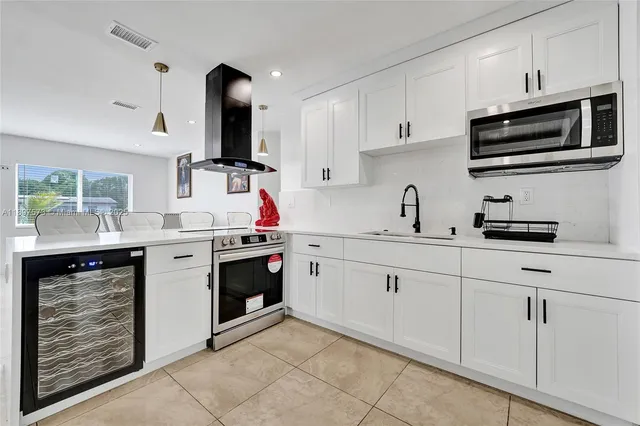 a kitchen with stainless steel appliances granite countertop a refrigerator and a stove