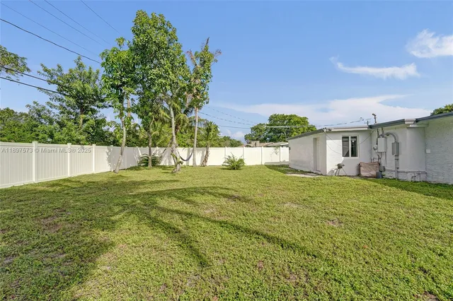 a view of a house with a backyard and a garden