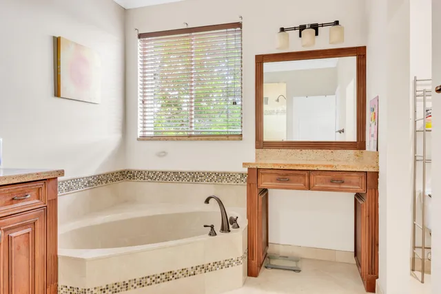 a bathroom with a bathtub and a window