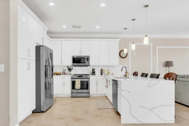 a kitchen with cabinets and stainless steel appliances
