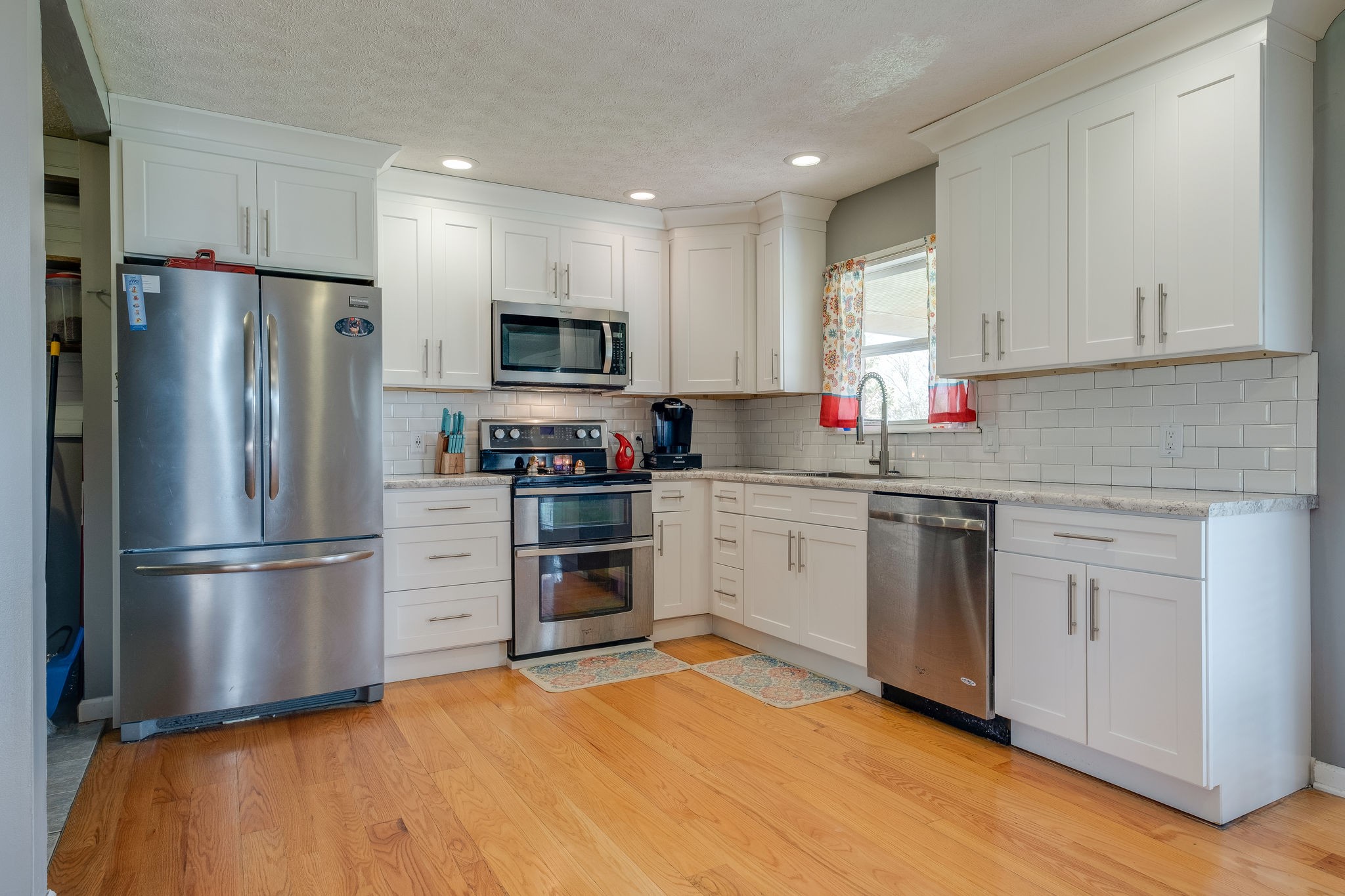 320 Crafton Road Portland, TN 37148 - Photo 12 of 28 a kitchen with a refrigerator sink and white cabinets