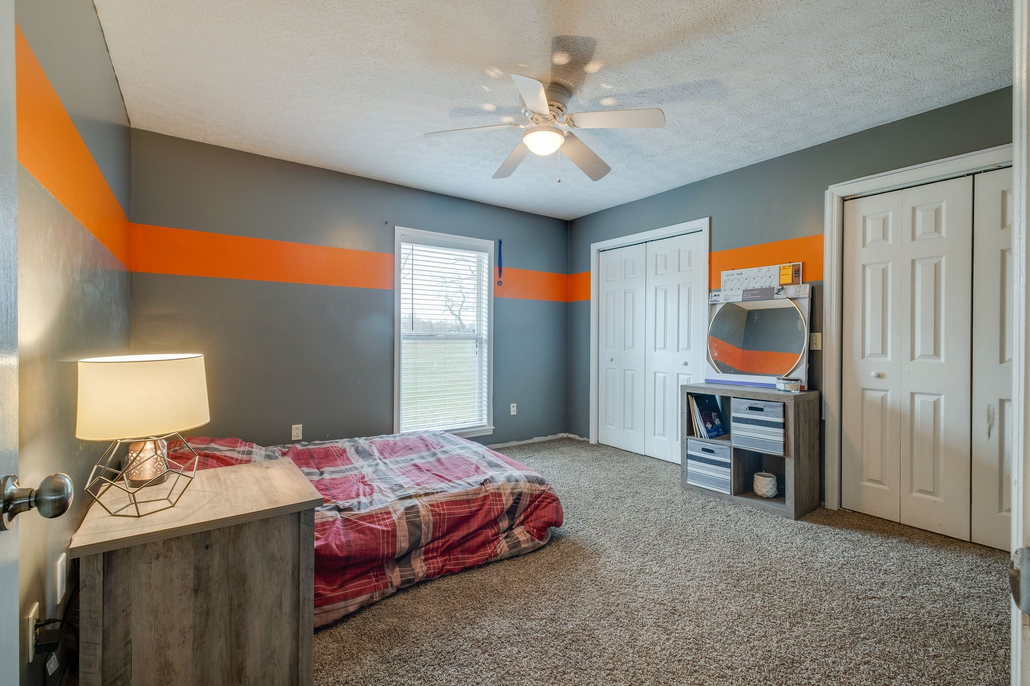 320 Crafton Road Portland, TN 37148 - Photo 18 of 28 a bedroom with a bed and a chandelier