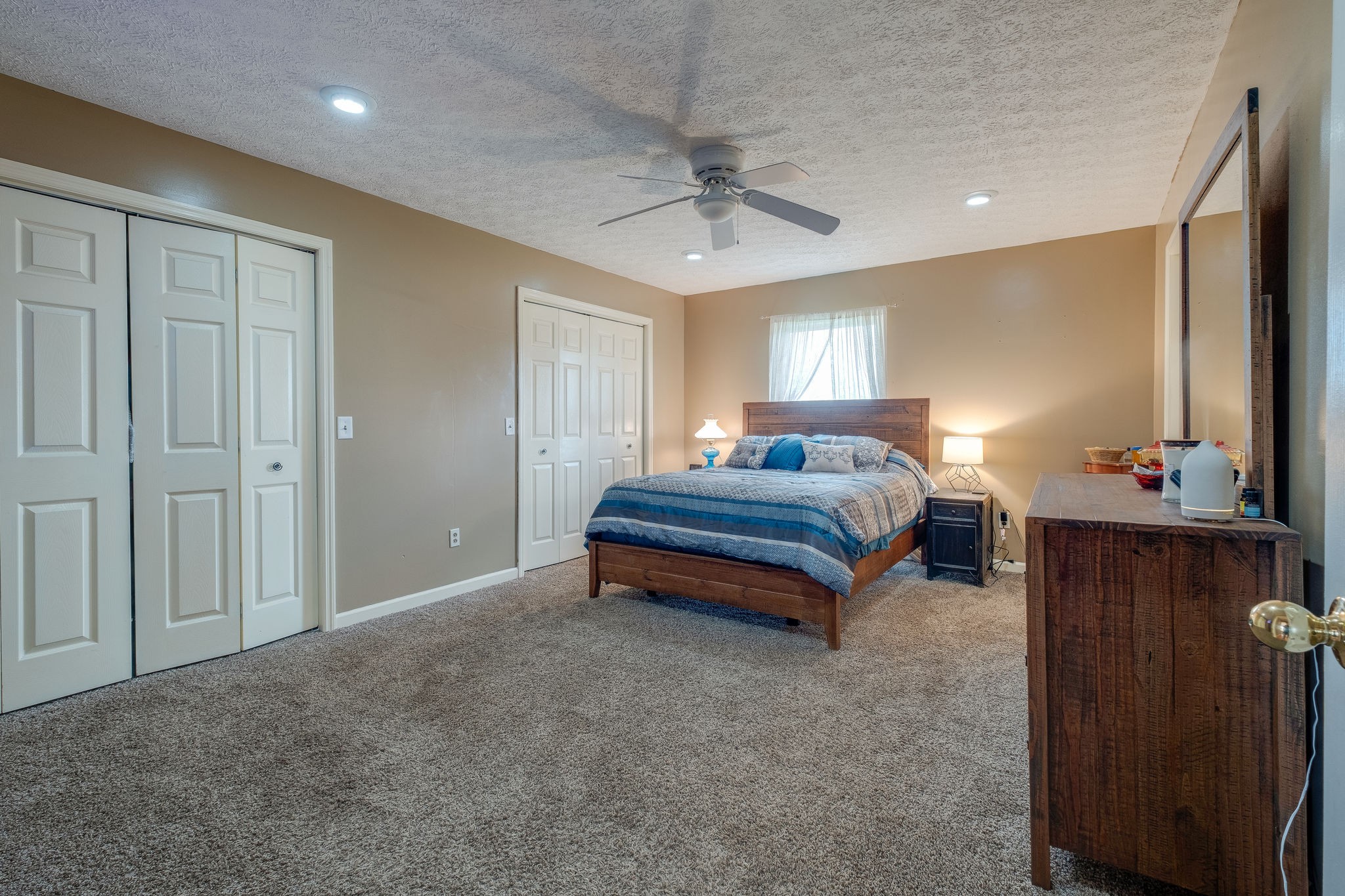 320 Crafton Road Portland, TN 37148 - Photo 19 of 28 a spacious bedroom with a bed and a chandelier