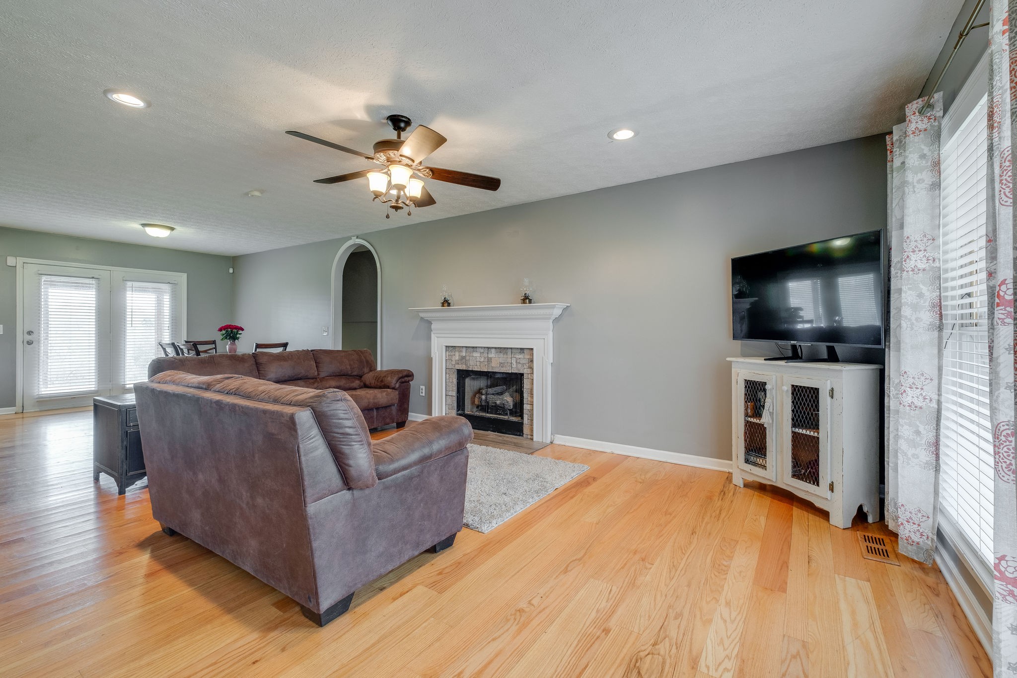 320 Crafton Road Portland, TN 37148 - Photo 7 of 28 a living room with furniture a flat screen tv and a fireplace