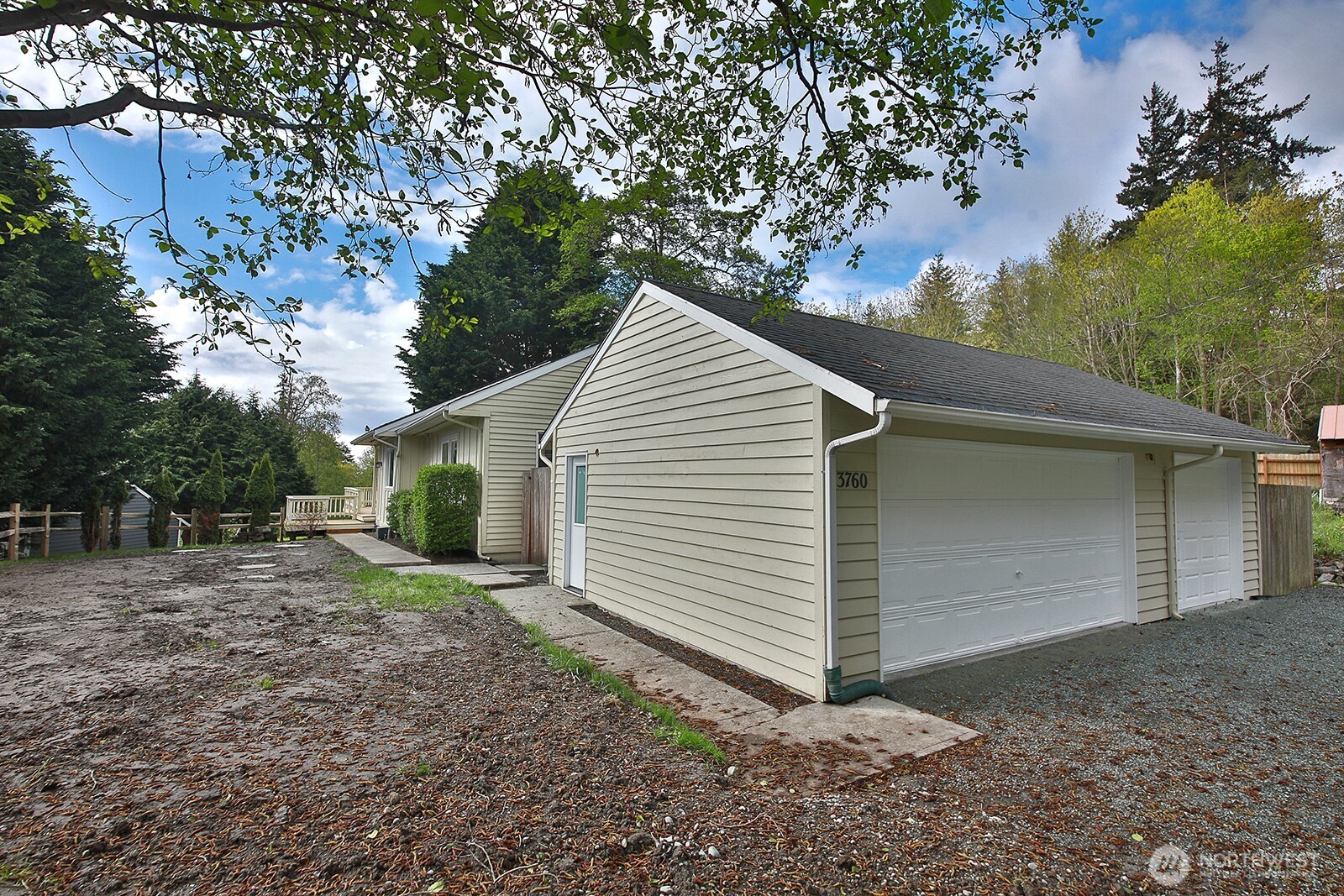 3760 Periwinkle Road Clinton, WA 98236 - Photo 2 of 34 a view of a house with a yard and garage