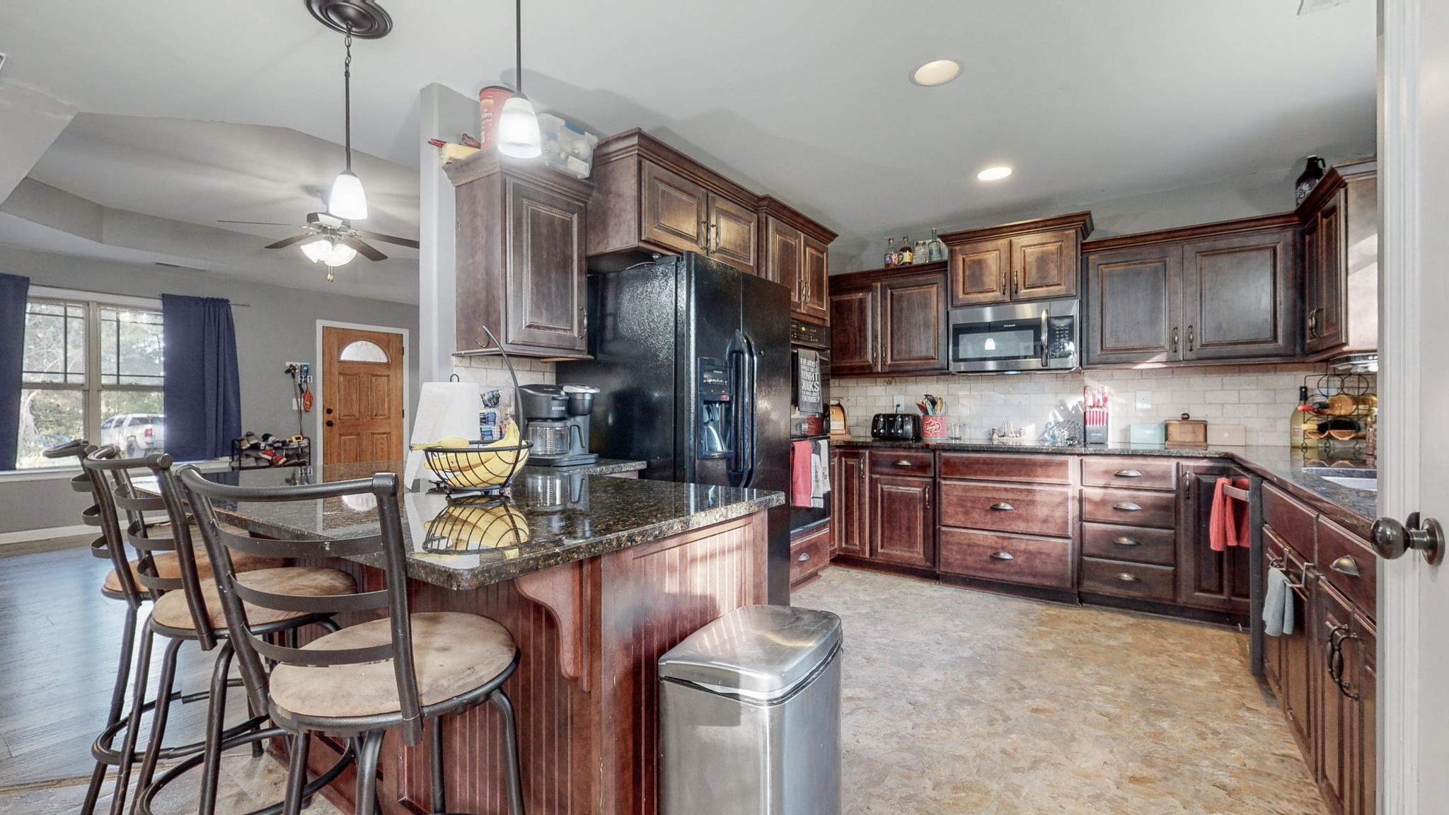 22 Warden Road Fayetteville, TN 37334 - Photo 6 of 34 a kitchen with stainless steel appliances granite countertop a stove top oven a sink a stove a dining table and chairs