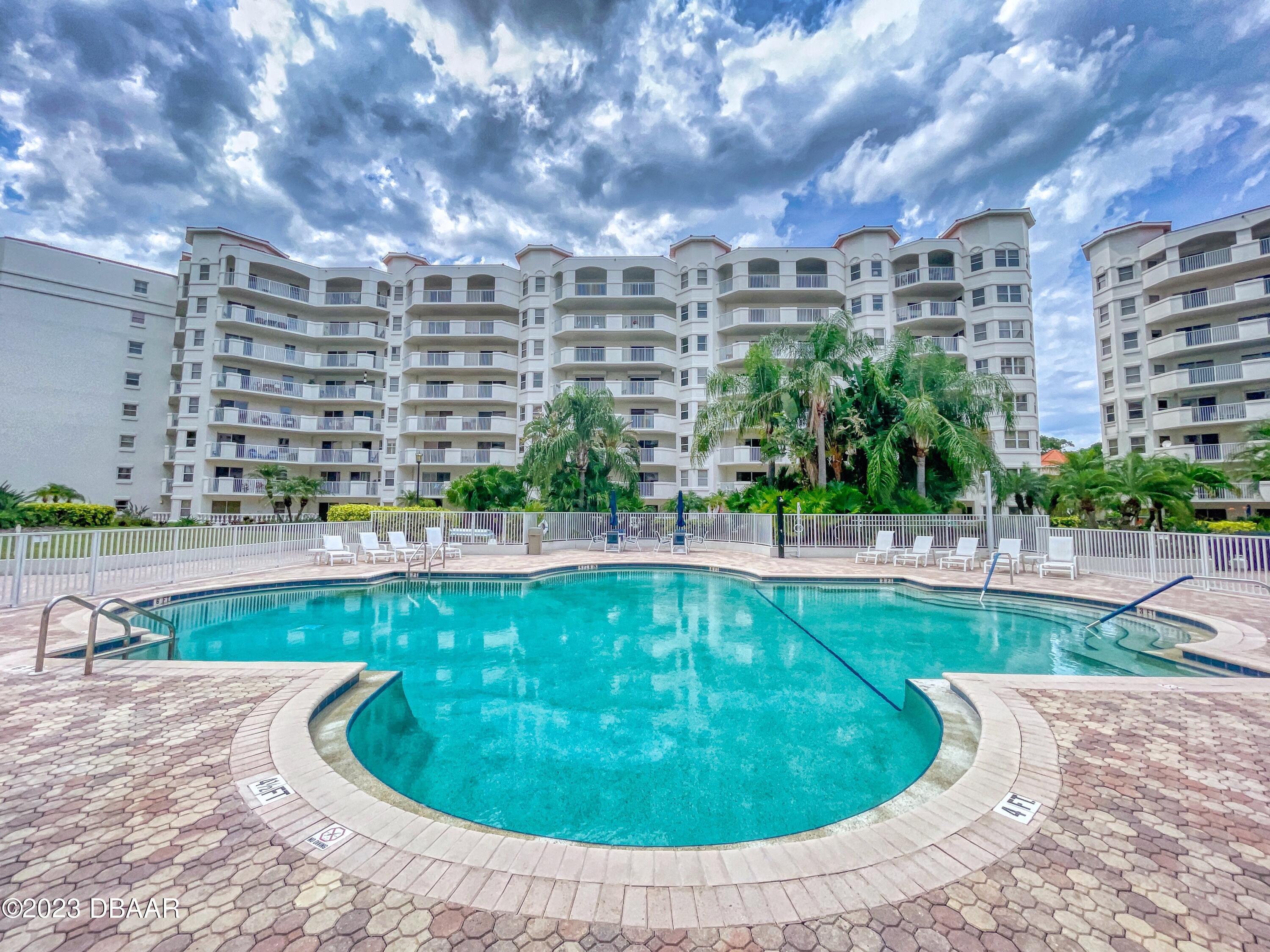 1 John Anderson Drive, Unit PH7 Ormond Beach, FL 32176 - Photo 130 of 134 a view of a swimming pool with a yard