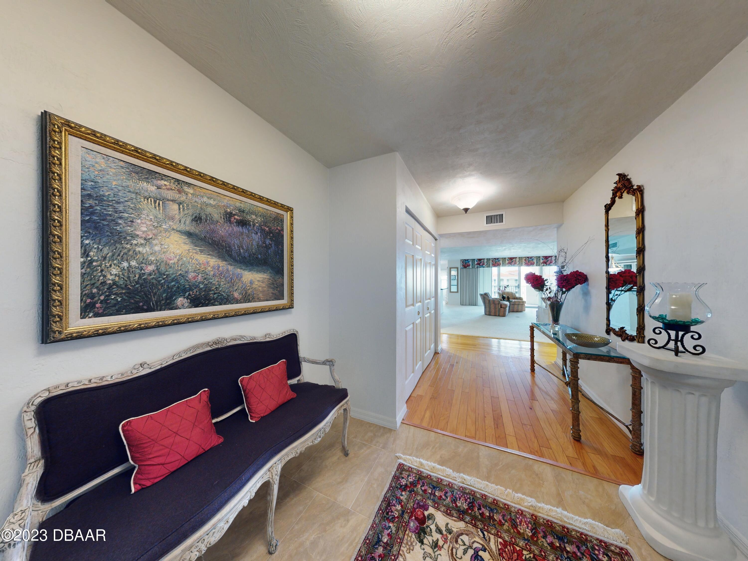 1 John Anderson Drive, Unit PH7 Ormond Beach, FL 32176 - Photo 2 of 134 a living room with furniture and a flat screen tv