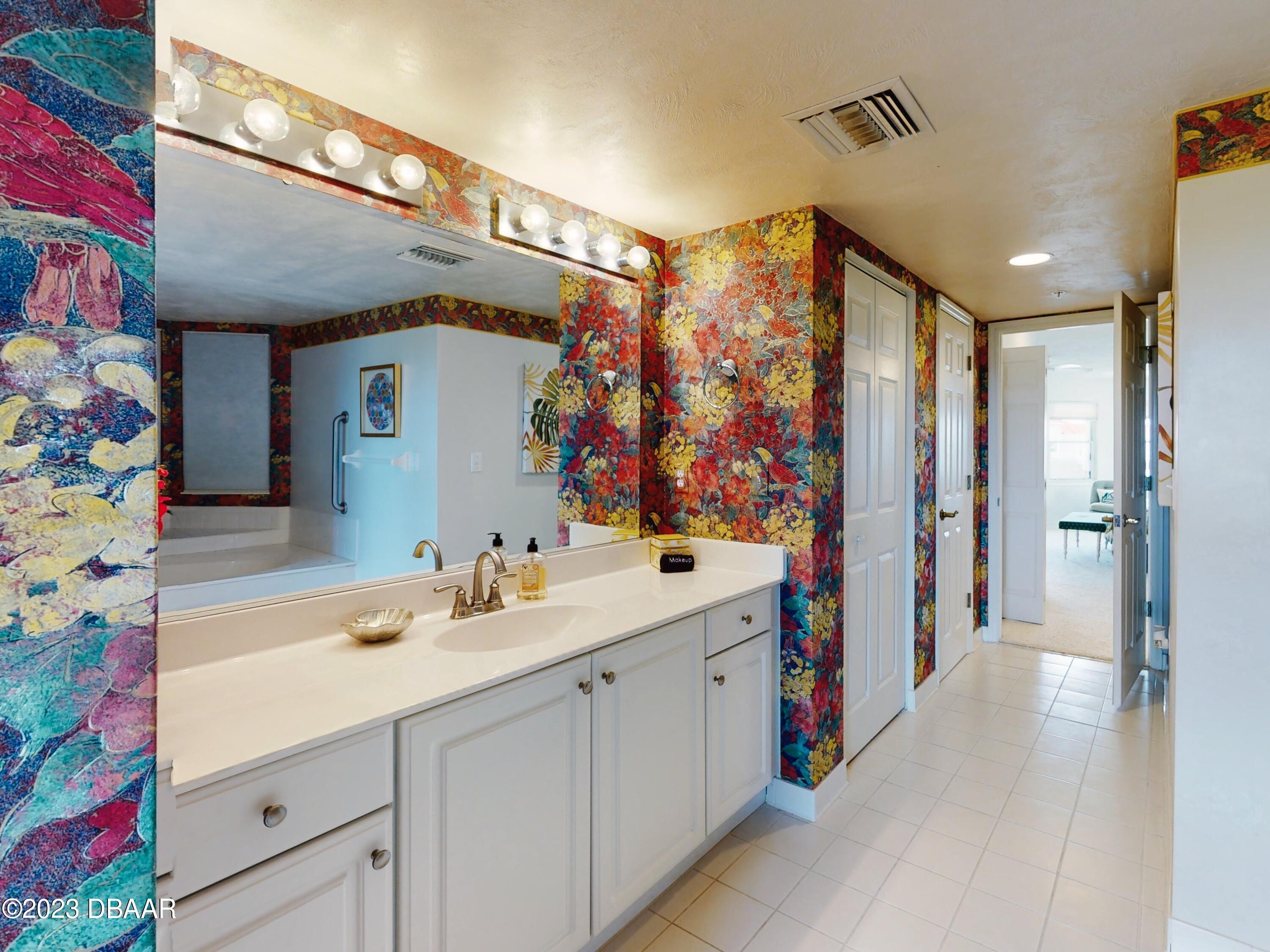 1 John Anderson Drive, Unit PH7 Ormond Beach, FL 32176 - Photo 33 of 134 a bathroom with a sink mirror and a shower