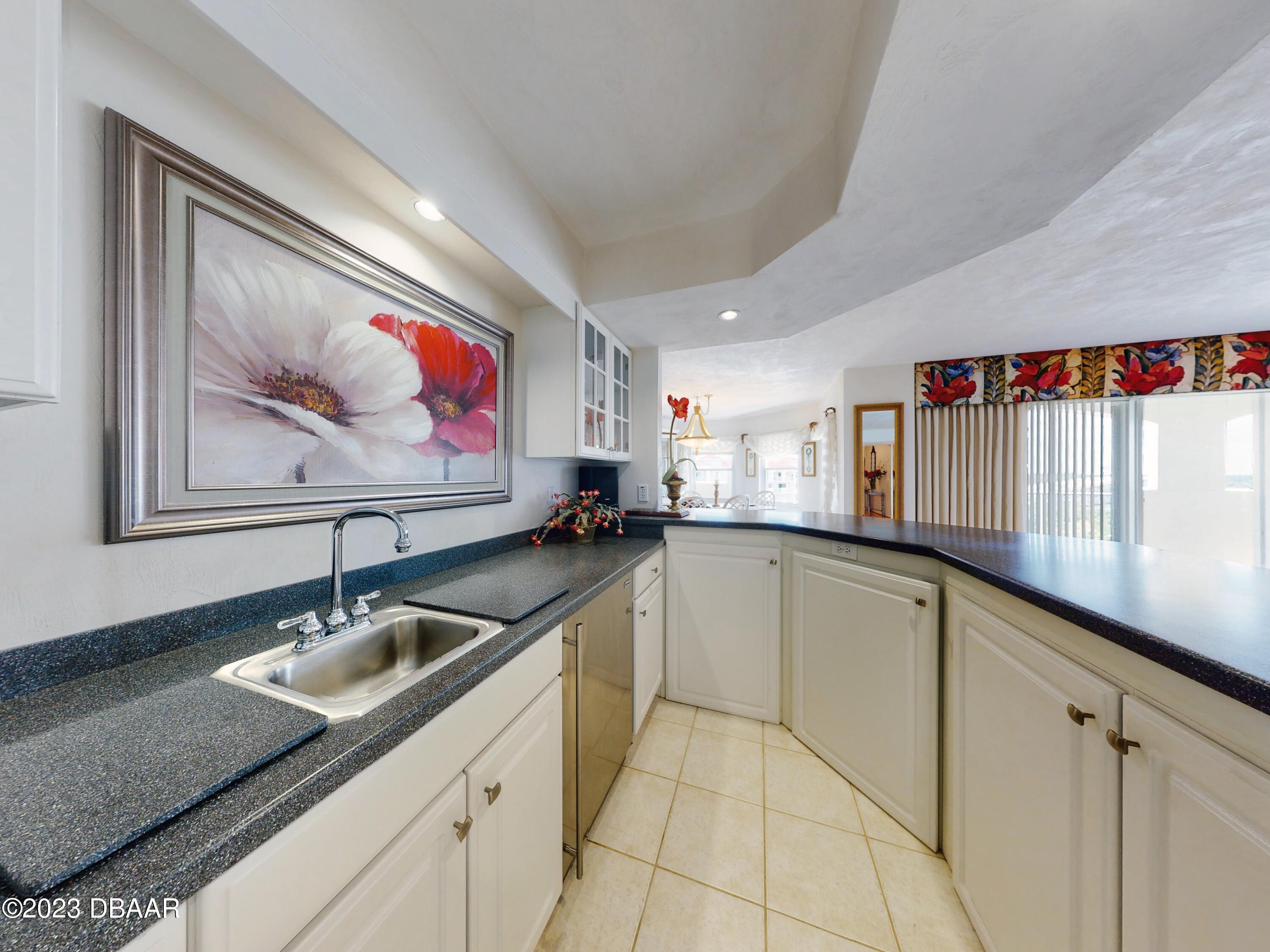 1 John Anderson Drive, Unit PH7 Ormond Beach, FL 32176 - Photo 36 of 134 a kitchen with granite countertop a sink and a stove top oven
