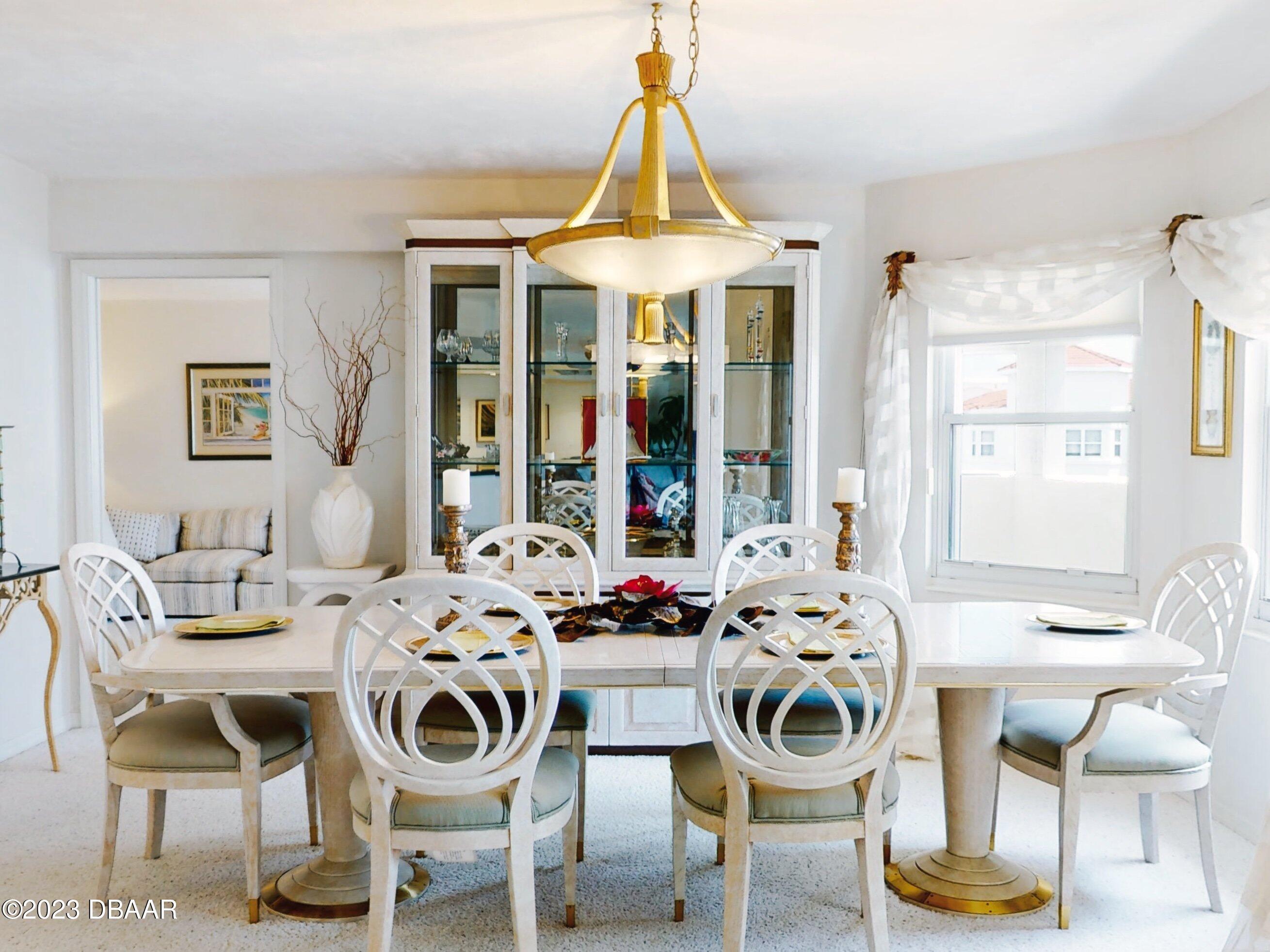 1 John Anderson Drive, Unit PH7 Ormond Beach, FL 32176 - Photo 44 of 134 a view of a dining room with furniture and windows