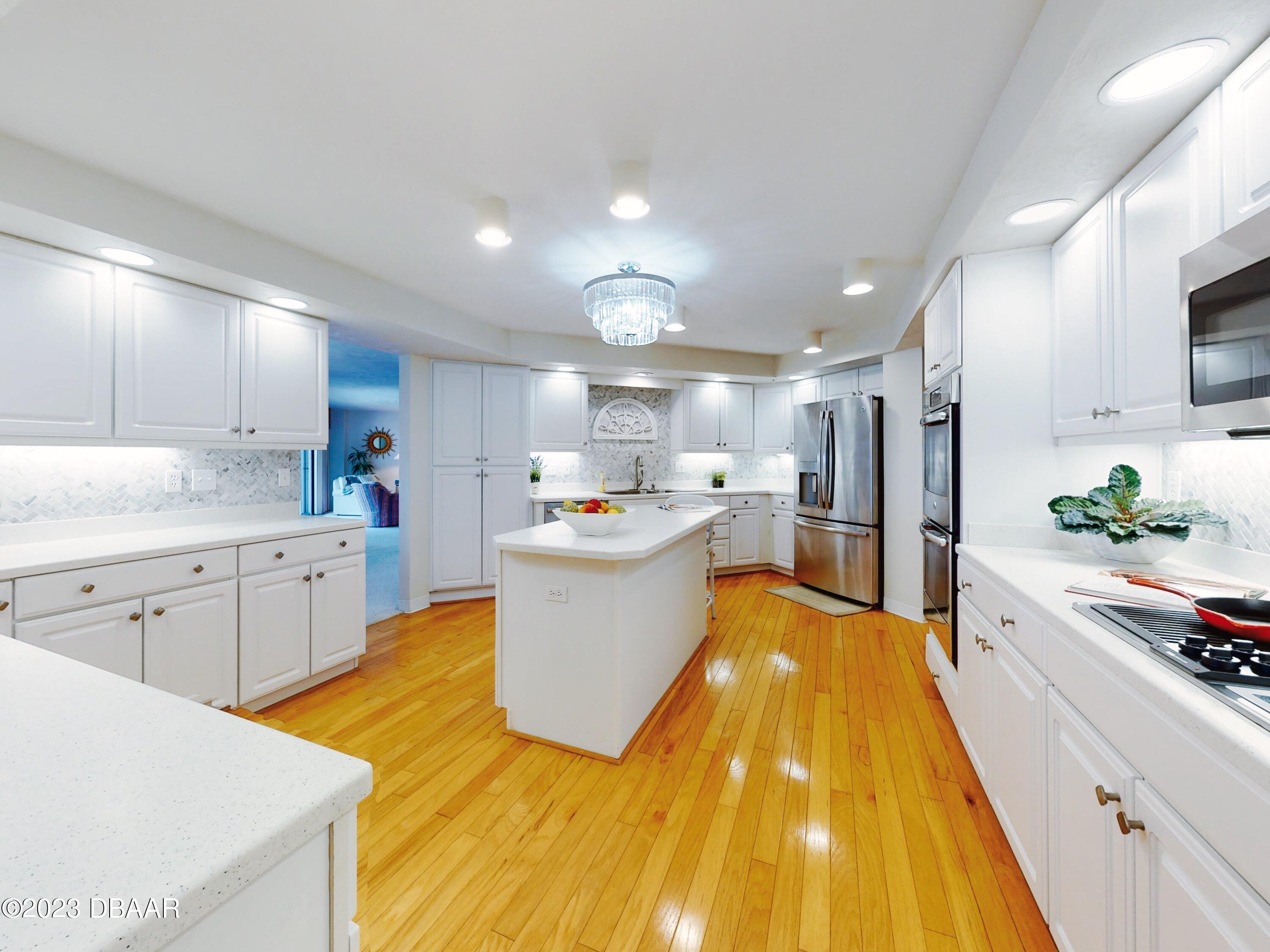 1 John Anderson Drive, Unit PH7 Ormond Beach, FL 32176 - Photo 50 of 134 a large kitchen with kitchen island a sink a stove and a refrigerator