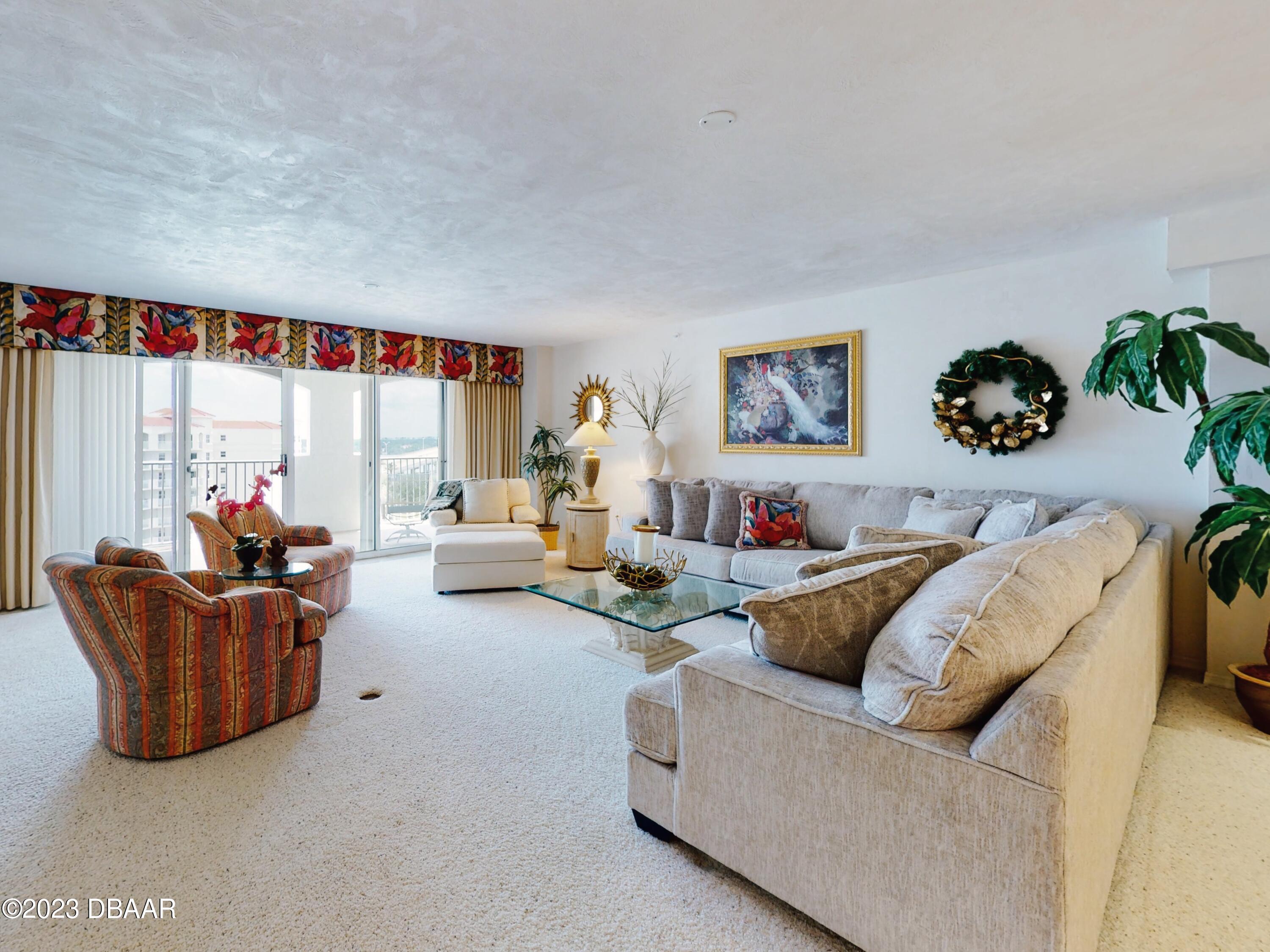 1 John Anderson Drive, Unit PH7 Ormond Beach, FL 32176 - Photo 5 of 134 a living room with furniture and a large window