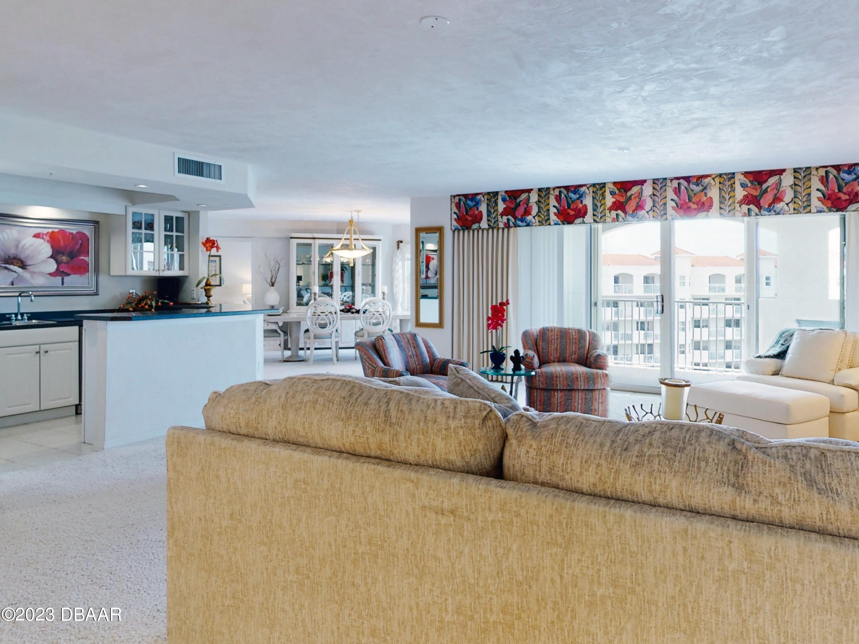 1 John Anderson Drive, Unit PH7 Ormond Beach, FL 32176 - Photo 6 of 134 a living room with furniture and a flat screen tv
