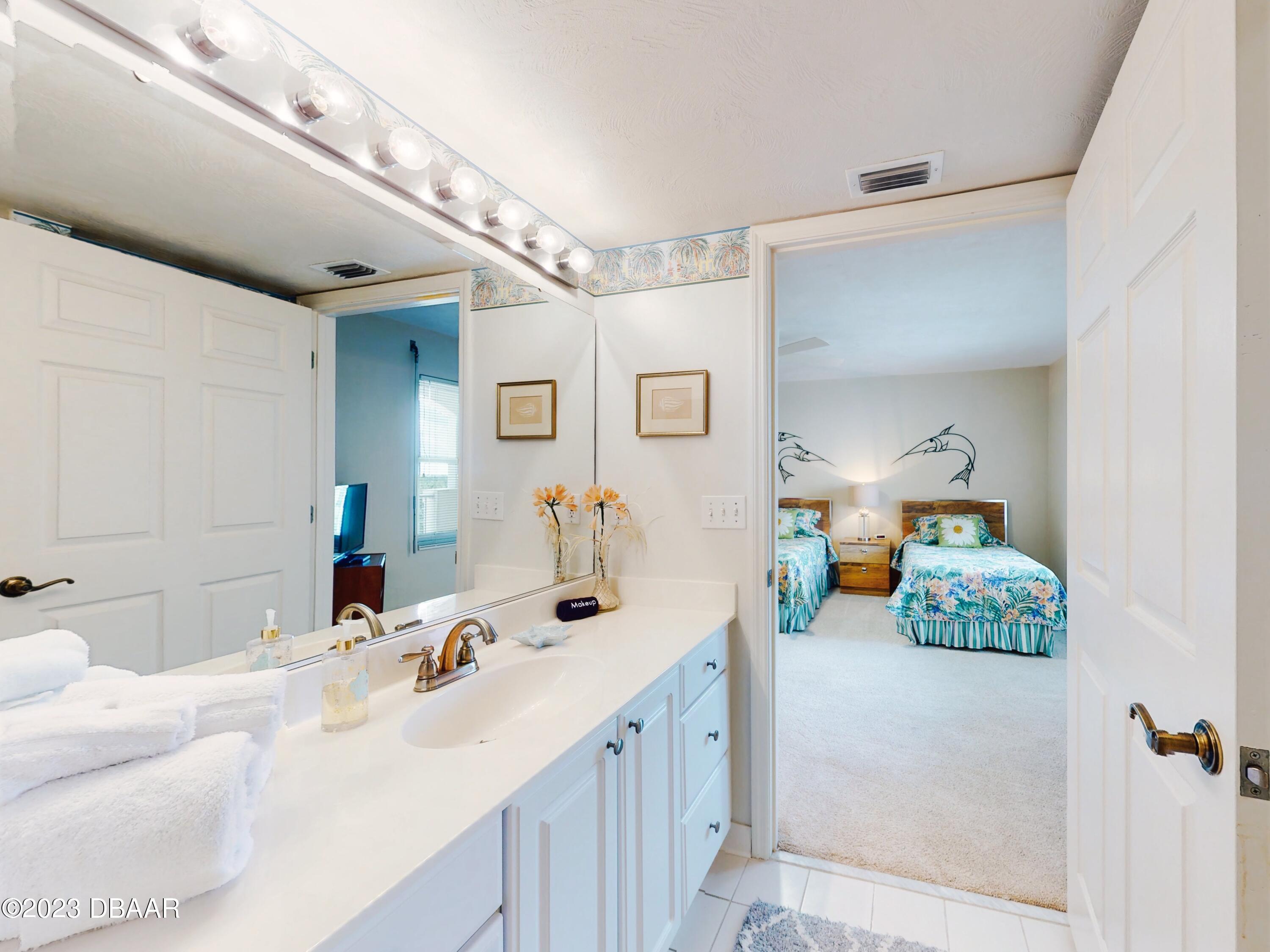 1 John Anderson Drive, Unit PH7 Ormond Beach, FL 32176 - Photo 66 of 134 a en suite bathroom with a double vanity sink and mirror